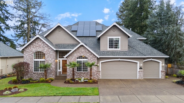 view of front of house featuring solar panels, a garage, and a front yard