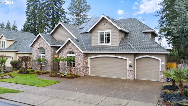 view of front facade with solar panels, a garage, and a front lawn