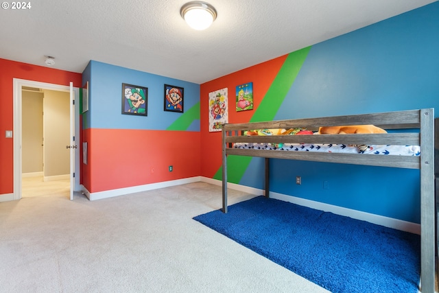 bedroom featuring carpet and a textured ceiling