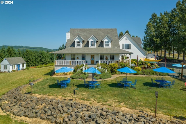 view of front of property with a wooden deck and a front yard