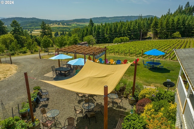 view of home's community featuring a mountain view and a patio