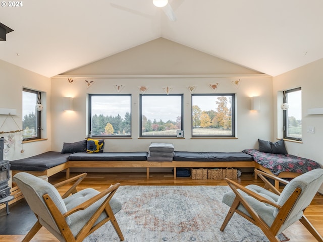 living room with a wealth of natural light, light hardwood / wood-style floors, and lofted ceiling