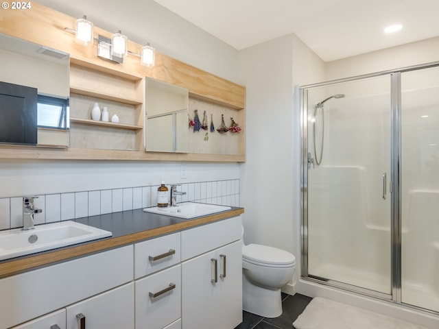 bathroom with toilet, vanity, tile patterned flooring, and a shower with door