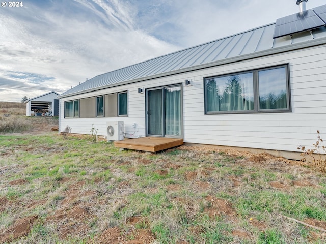 rear view of house with a wooden deck and ac unit