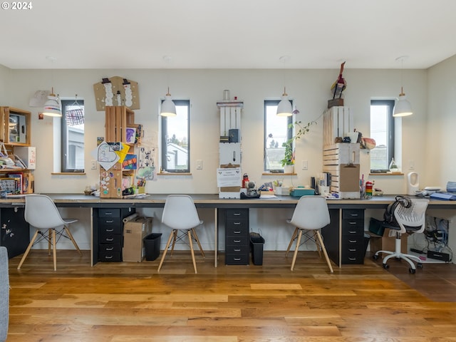 office area with built in desk, wood-type flooring, and a wealth of natural light