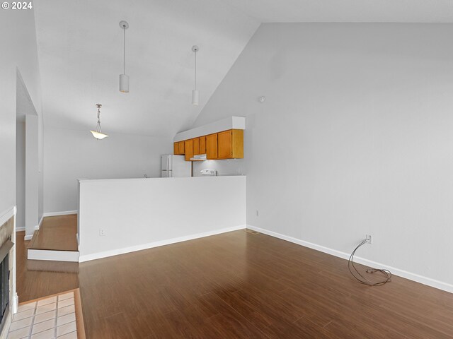 unfurnished living room featuring light wood-type flooring and high vaulted ceiling