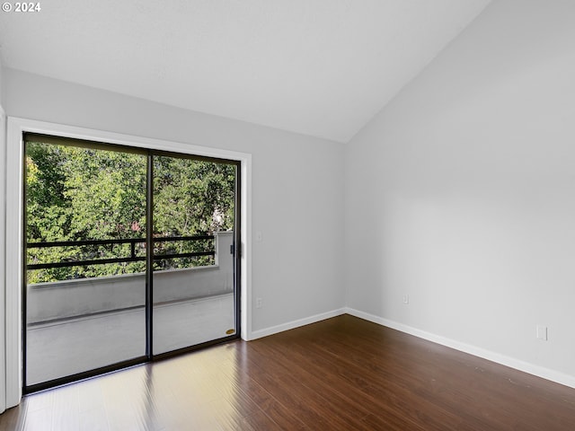 spare room featuring hardwood / wood-style flooring and vaulted ceiling