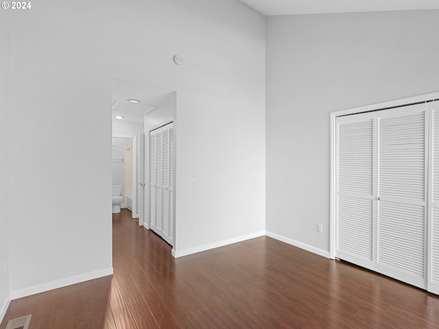 unfurnished bedroom with recessed lighting, a closet, visible vents, dark wood-type flooring, and baseboards