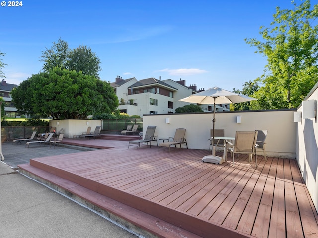 wooden deck with a residential view and fence