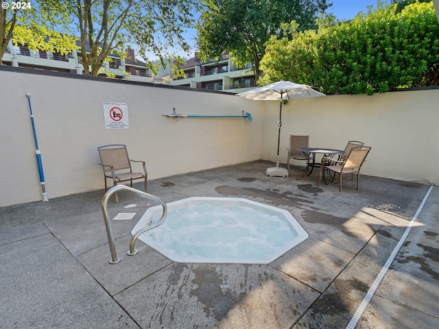 view of swimming pool with a patio area and fence