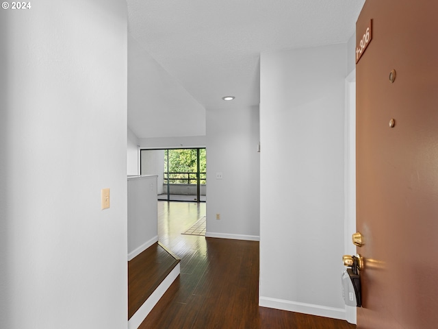 hallway featuring baseboards, dark wood-style flooring, and recessed lighting