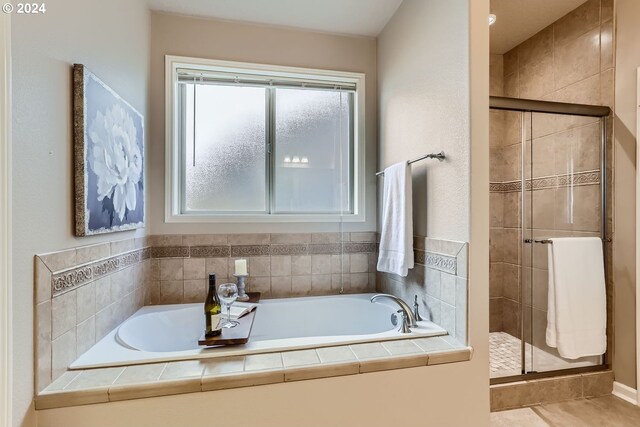 bathroom with separate shower and tub