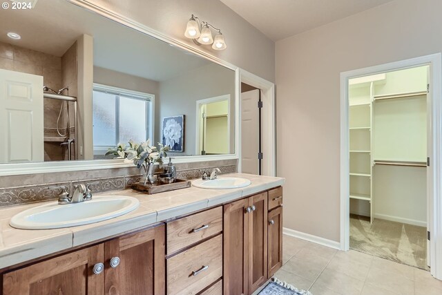 bathroom featuring vanity, tile patterned floors, and an enclosed shower