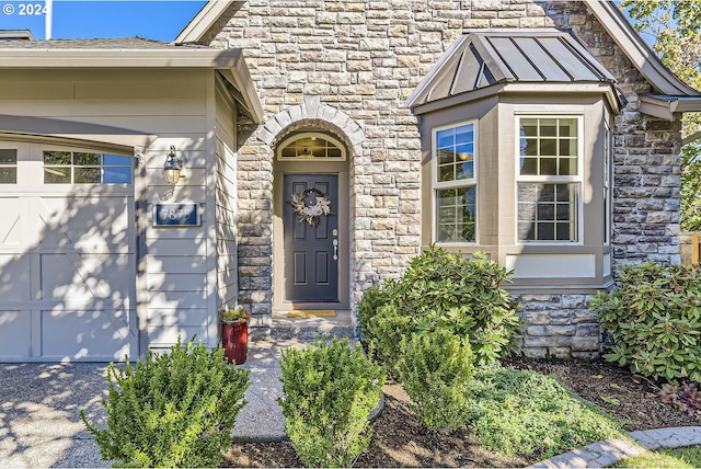 doorway to property with a garage