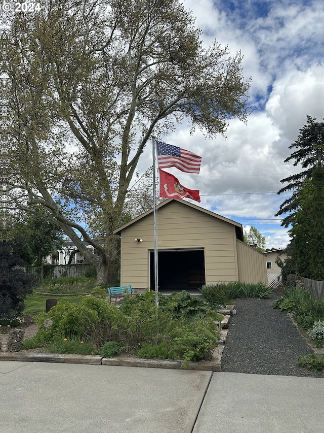 view of property exterior with a garage and an outbuilding