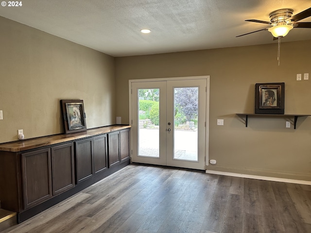 doorway to outside with a textured ceiling, light hardwood / wood-style flooring, french doors, and ceiling fan