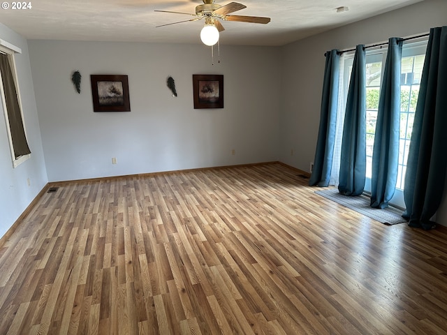 empty room with light hardwood / wood-style floors and ceiling fan