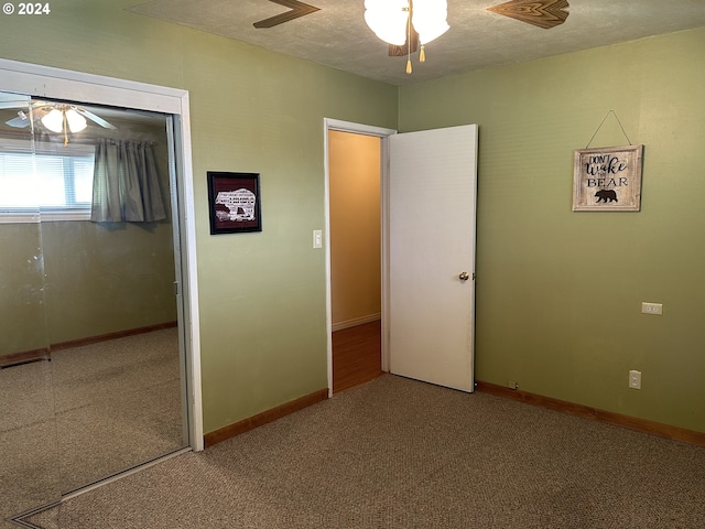 unfurnished bedroom with ceiling fan, a closet, and carpet