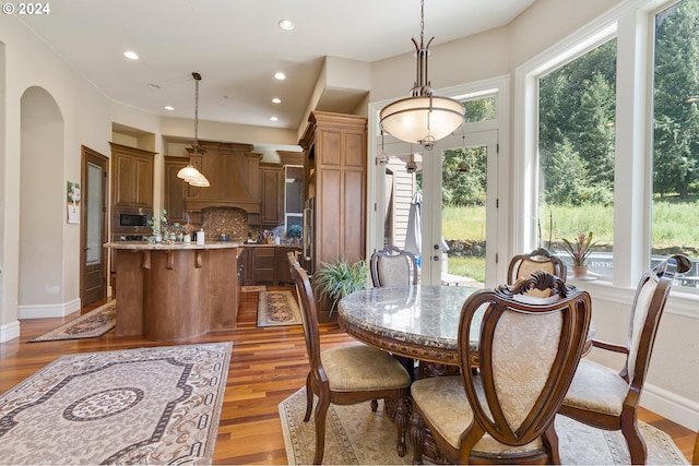 dining space featuring plenty of natural light and light wood-type flooring