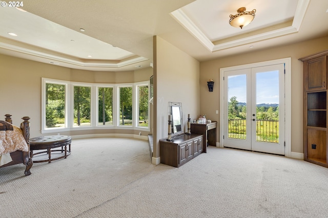 interior space with light colored carpet, french doors, and a tray ceiling