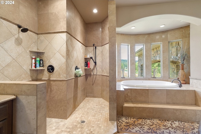 bathroom with tile patterned flooring, vanity, and separate shower and tub