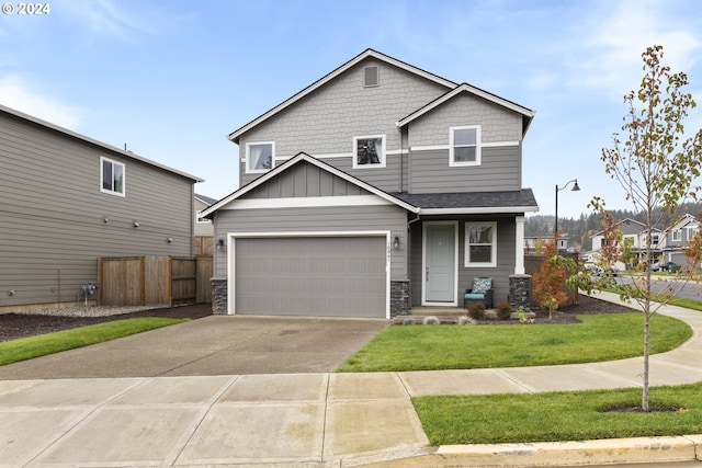 craftsman-style house with a front yard and a garage