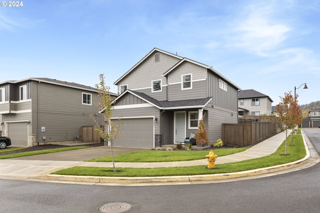 view of front of house with fence, concrete driveway, a garage, stone siding, and board and batten siding