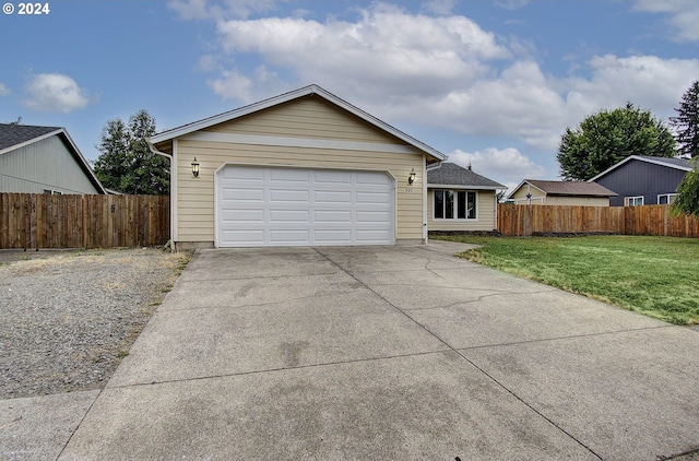 ranch-style house featuring a garage and a front lawn