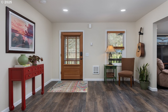 foyer with recessed lighting, heating unit, baseboards, and wood finished floors