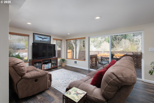 living area with a wealth of natural light and dark wood-style flooring