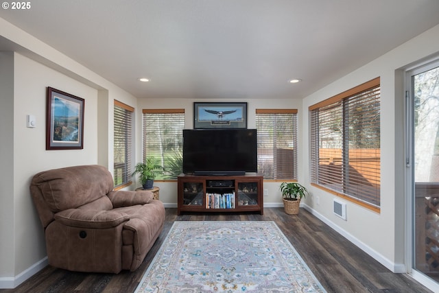 living room with recessed lighting, visible vents, baseboards, and dark wood-type flooring