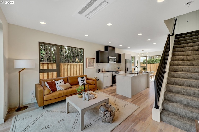 living room with sink and light hardwood / wood-style floors