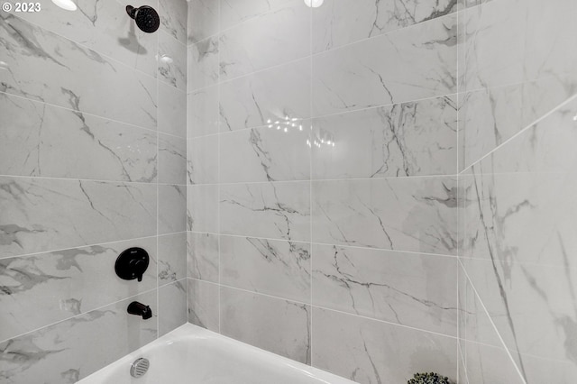 bathroom with shower / washtub combination