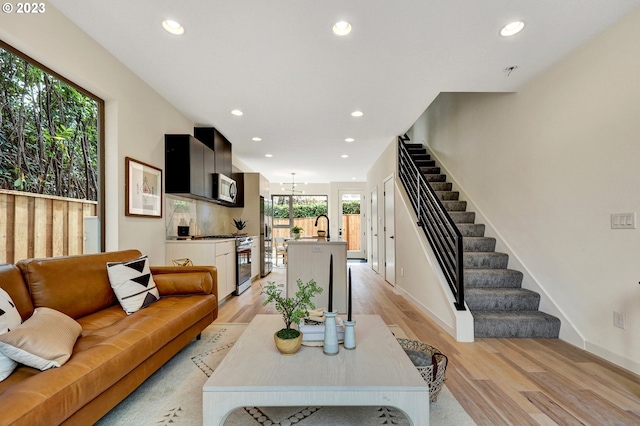 living room with a wealth of natural light and light hardwood / wood-style flooring