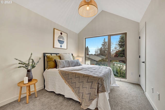 carpeted bedroom with vaulted ceiling and baseboards
