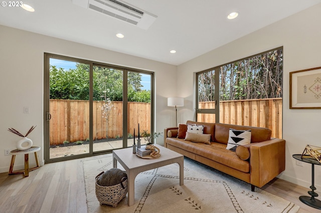 living room featuring a wealth of natural light and light wood-type flooring