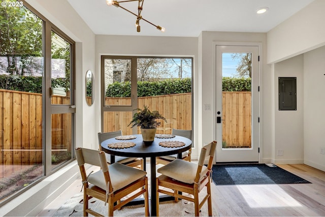 sunroom with a wealth of natural light and an inviting chandelier