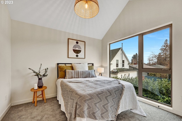 carpeted bedroom with high vaulted ceiling