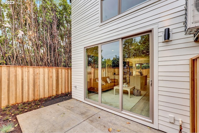 view of exterior entry featuring a patio area