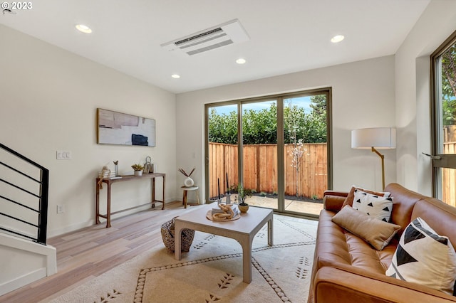 living area with recessed lighting, stairs, visible vents, and light wood-style flooring