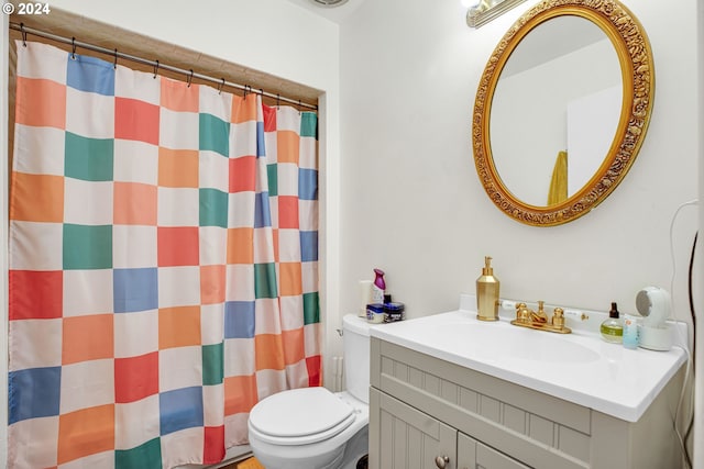 bathroom featuring vanity, toilet, and a shower with curtain