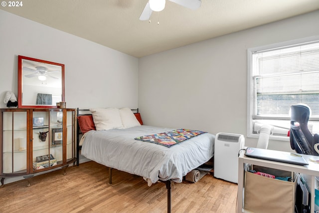 bedroom with light wood-type flooring and ceiling fan