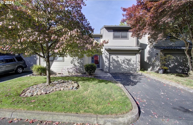 view of front of house with a garage and a front lawn