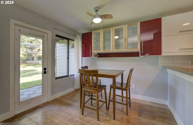 dining area with ceiling fan and light wood-type flooring