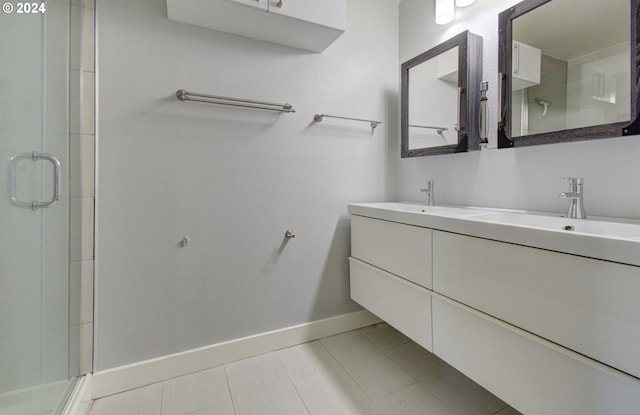 bathroom with tile patterned flooring, vanity, and a shower with shower door