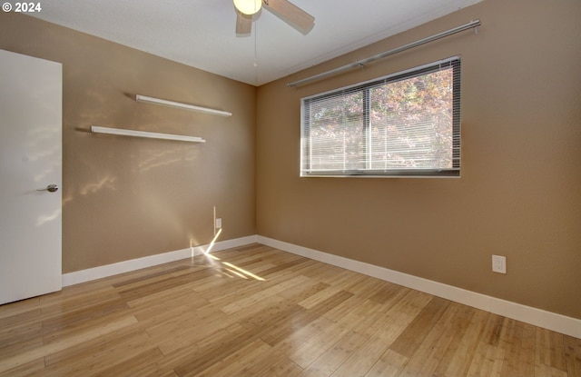 empty room featuring ceiling fan and hardwood / wood-style flooring