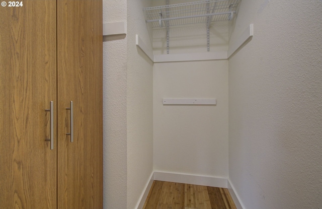 spacious closet featuring hardwood / wood-style floors