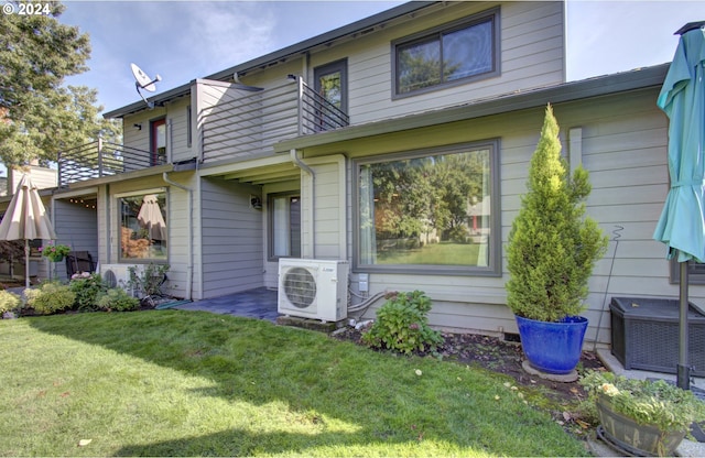 view of front facade with ac unit, a front lawn, and central air condition unit