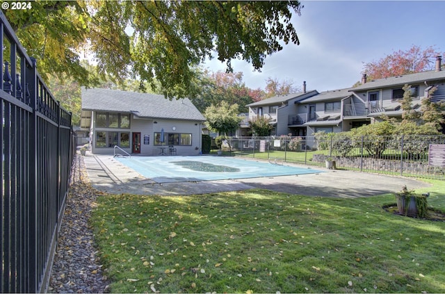 view of swimming pool with a lawn and a patio