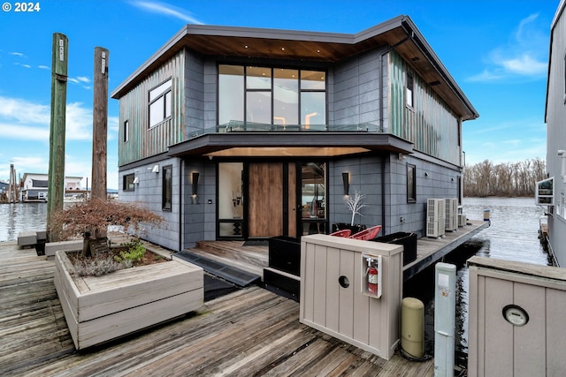 view of front facade with a deck with water view